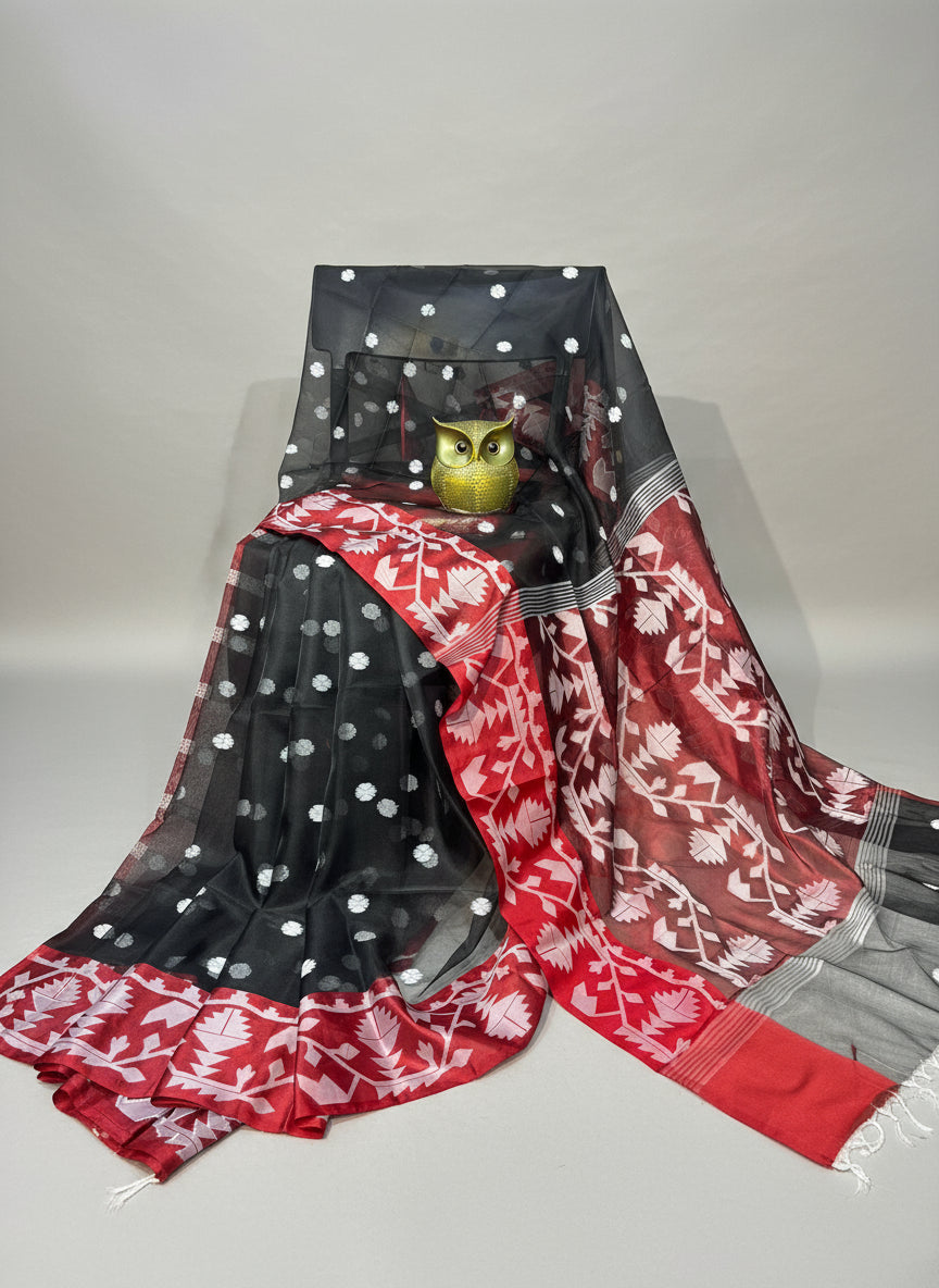 Black and red saree with white patterns on a white background